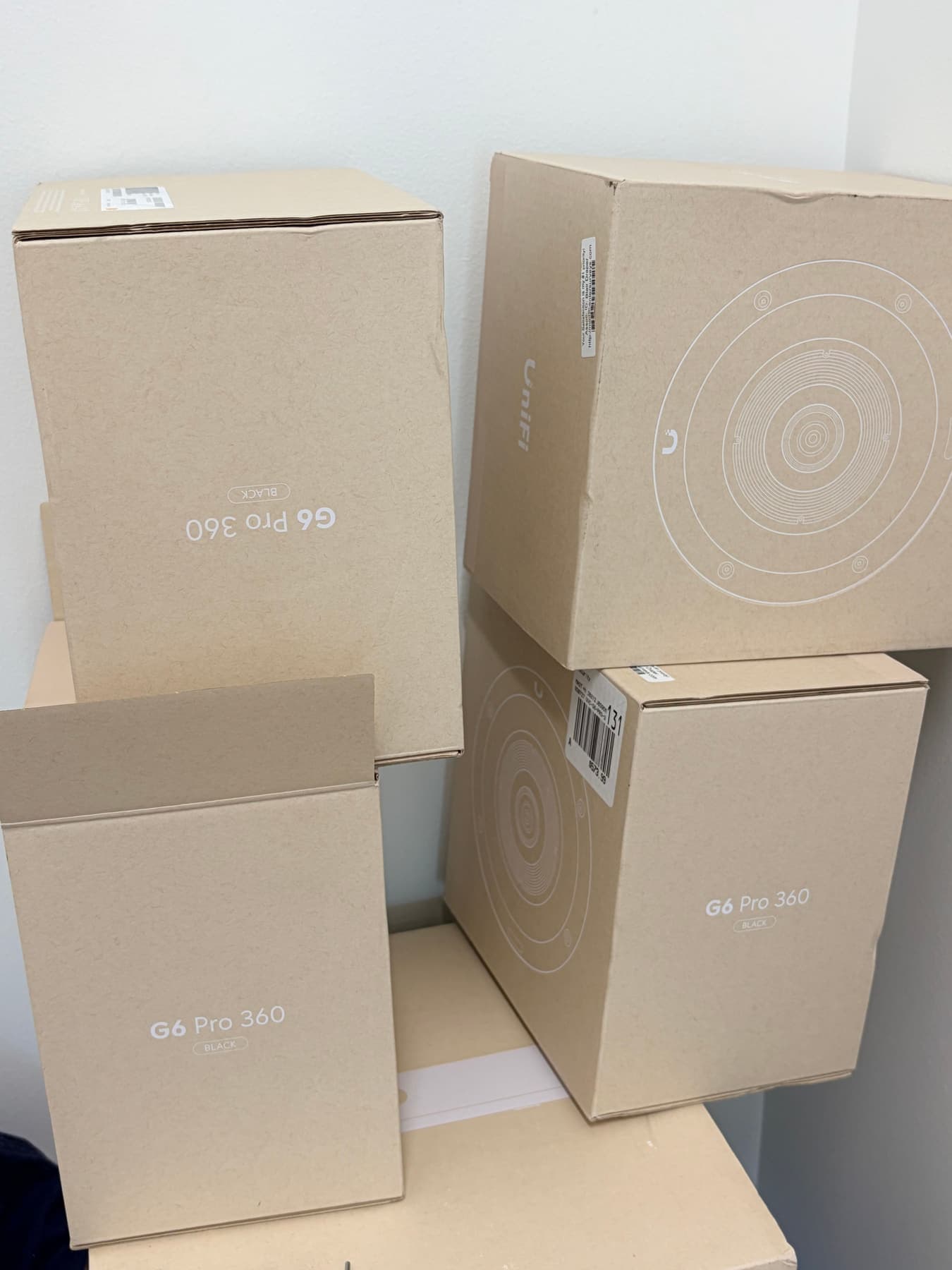 Four UniFi G6 Pro 360 cameras staged for a Dallas commercial install
