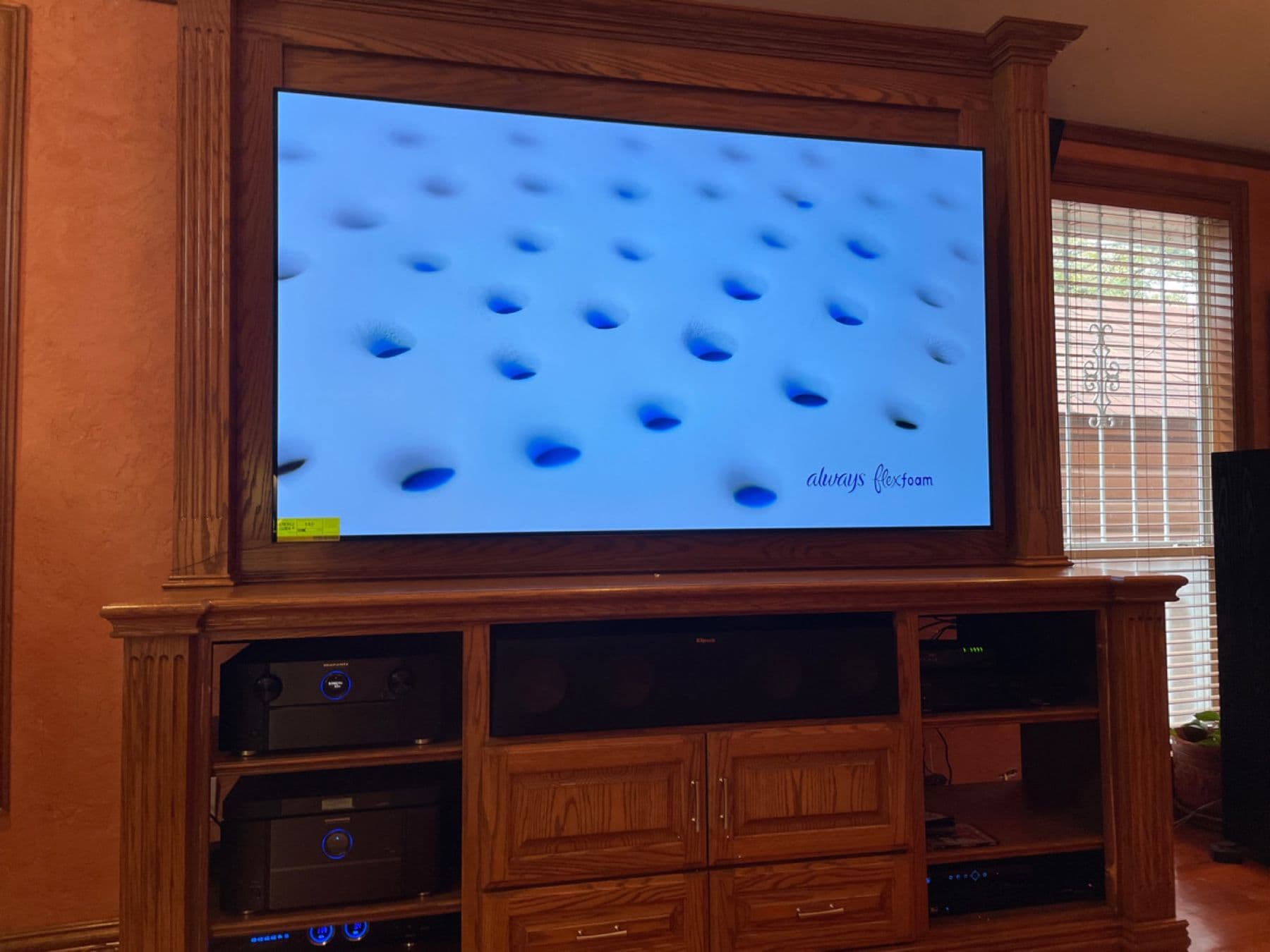 Home theater with a large TV, Marantz receivers and a Klipsch center channel in an oak built-in, Dallas