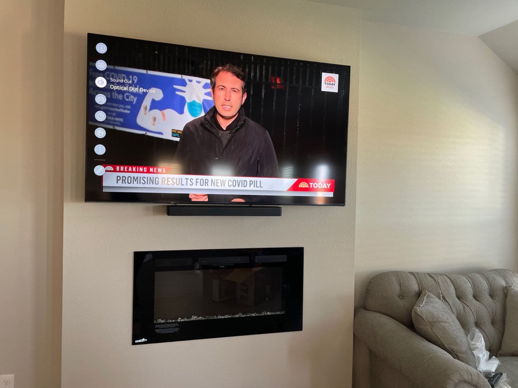 Mounted TV with soundbar above a fireplace, wires hidden in-wall, Dallas install