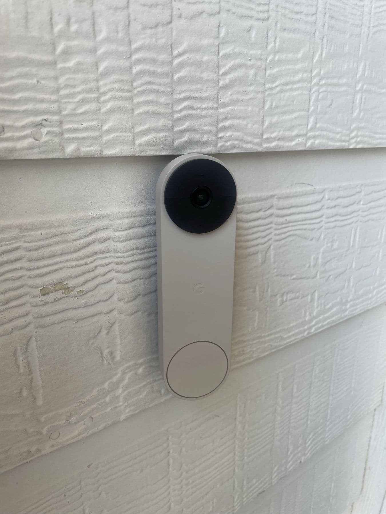Google Nest doorbell installed on white lap siding at a Dallas home
